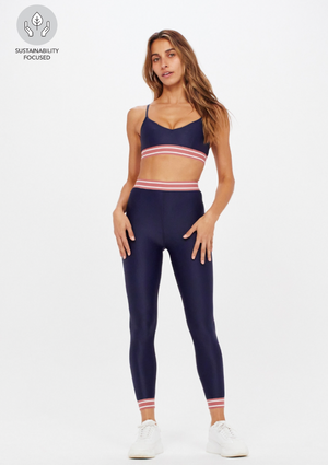 Balance Midi Pant - Navy, by The Upside Strike a pose in our Balance Midi Pant  Mid-Rise 7/8 length leg printed Our Recycled Super Soft fabric Breathable, quick drying and moisture wicking Contrast arrow logo at back Contrast stripe elastic waistband